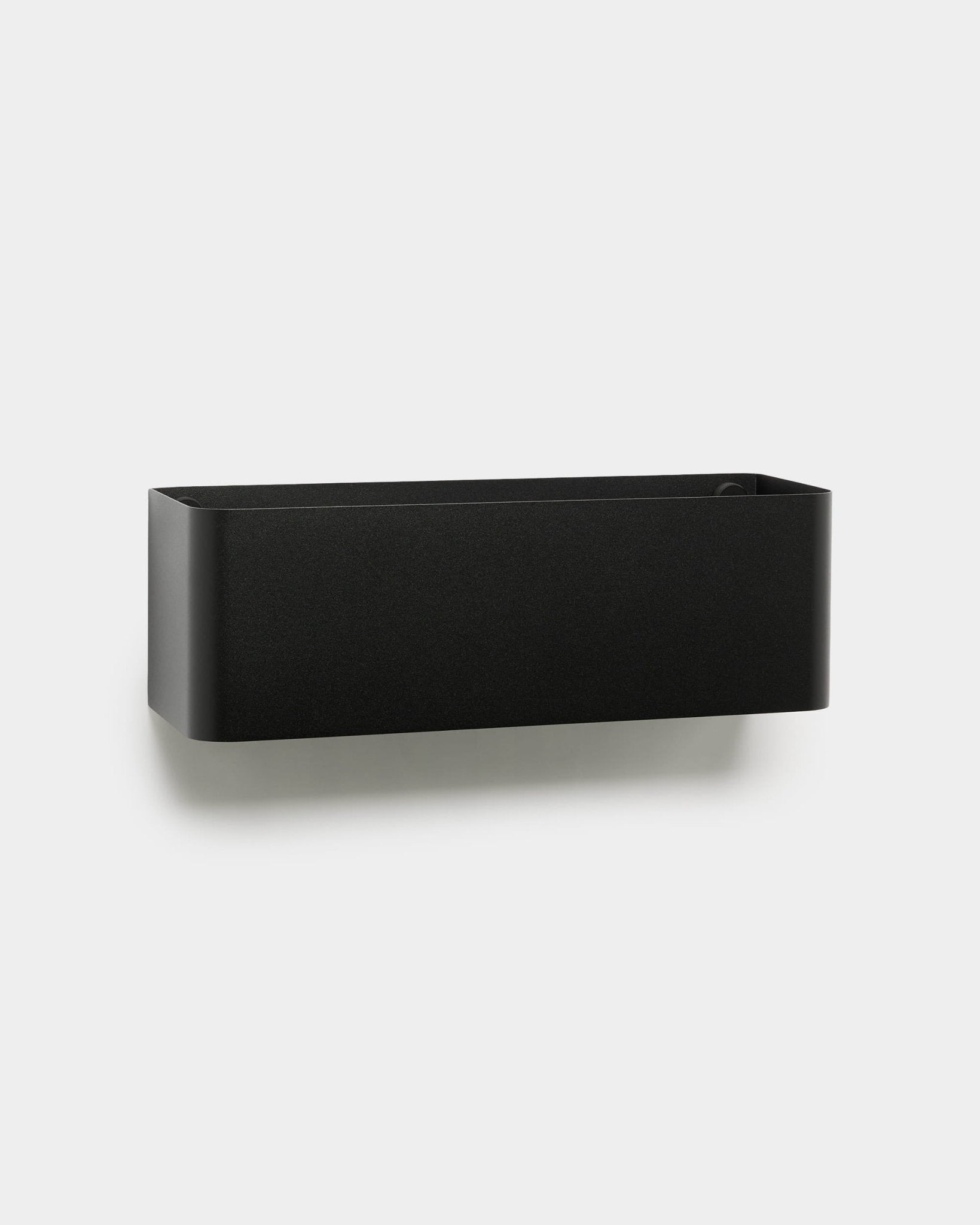 The Norr | Plant Box by WoodUpp is a black, wall-mounted planter with rounded edges, designed to complement Nordic interiors and acoustic wood panels.